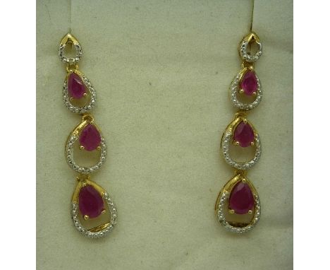 A pair of silver, ruby and diamond earrings