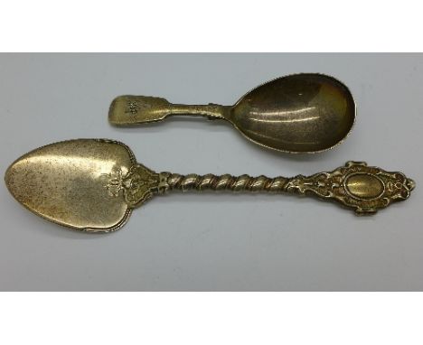 A Victorian silver caddy spoon, London 1866, by Henry Holland and a Victorian silver cake knife, London 1862, by Francis Higg