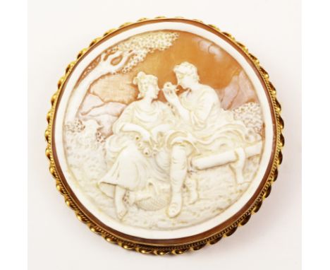 Large circular cameo brooch depicting courting couple in hallmarked 9ct gold twist surround 7cm   Condition Report   Click he