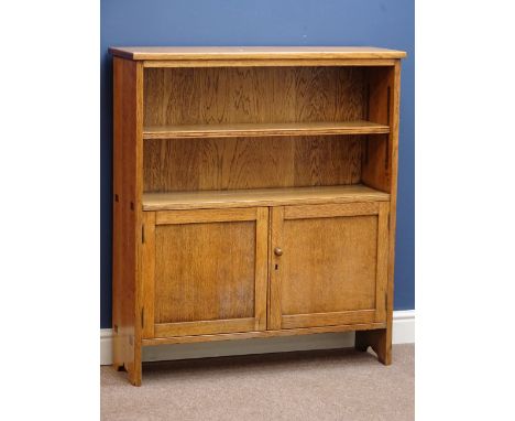 Oak vernacular bookcase, single adjustable shelf above double panelled cupboard, visible joints to sides, W95cm, H107cm, D28c