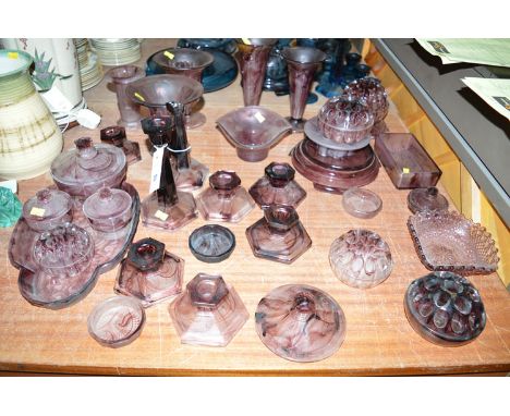 A large quantity of purple cloud glass, including: vases; part trinket sets; flower vases; etc.