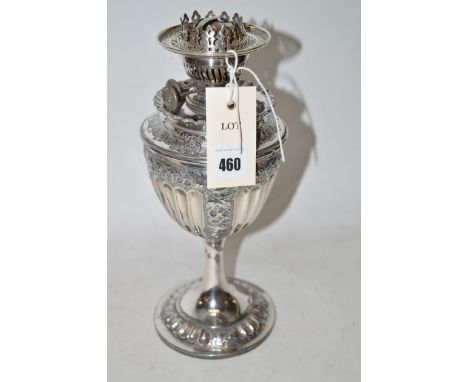 A silver plated oil lamp with embossed decoration.