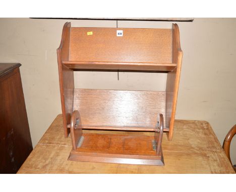 An oak book trough of two-tiers; together with an extending oak book trough with tapering plinth base.