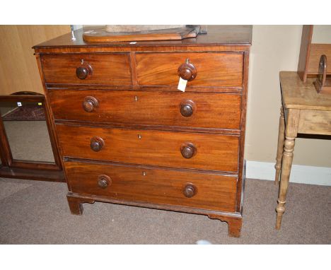 A Victorian mahogany chest of drawers of two short and three long graduated drawers fitted turned wooden handles, raised on b