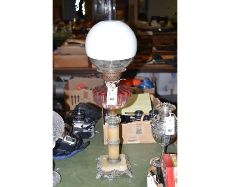 A Victorian oil lamp on onyx column, with ruby glass reservoir.