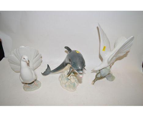 Two Lladro birds; and a Goebel model of a dolphin.