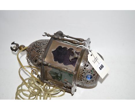 A Middle Eastern metal light fitting with bird decoration and coloured glass panels.