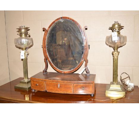 A pair of 19th Century corinthian column pattern table oil lamps, with cut glass reservoirs on brass corinthian columns with 