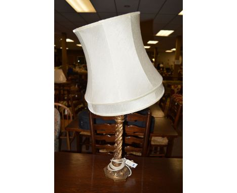A carved and gold painted table lamp and shade.
