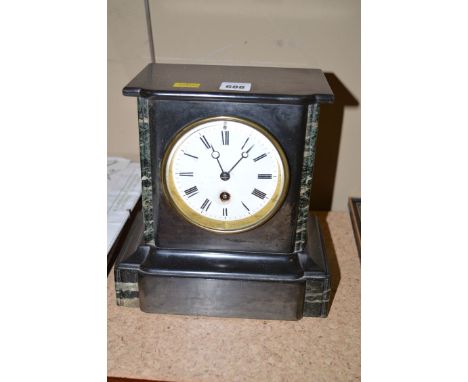 A Victorian mantel clock with circular white enamel dial and roman numerals, in black slate and marble architectural style ca