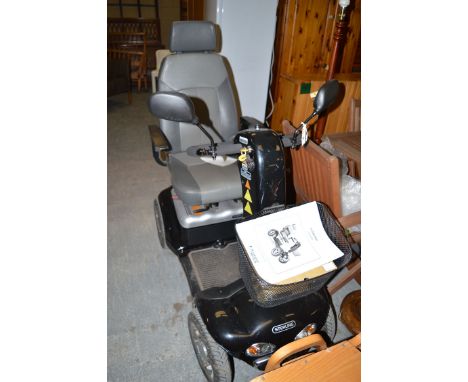 A Sterling Diamond invalid scooter, by Sunrise Medical, complete with instruction manual and battery charger.