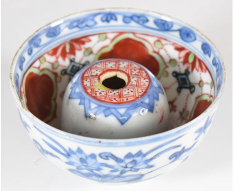 Chinese Kangxi porcelain tea bowl with pierced domed interior, with three cutouts to base, pierced domed captive loose stone 