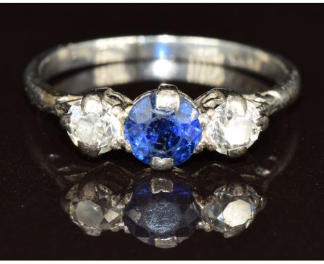 A platinum ring set with a round cut sapphire of approximately 0.5ct and two diamonds each approximately 0.2ct, 3.5g, size N