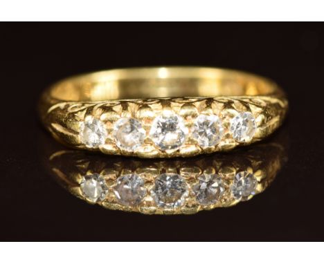 An 18ct gold ring set with five diamonds, 3.7g, size L