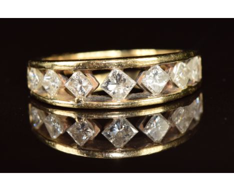 A 14k gold ring set with seven graduating princess cut diamonds, the centre diamond approximately 0.15ct, 3.7g, size M/N