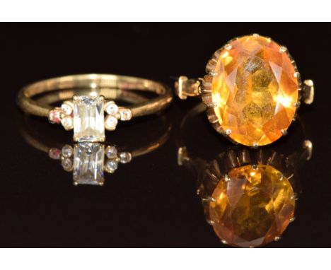 A 14k gold ring set with an oval cut yellow sapphire (4.8g, size K) and a 14k gold ring set with cubic zirconia. (1.8g, size 