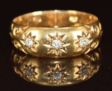 A c1910 18ct gold ring set with three old cut diamonds in star settings, 4.2g, size R&nbsp;