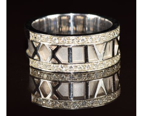 An 18ct white gold ring with Roman numeral decoration '2149' and set with twenty eight diamonds, 14.4g, size S