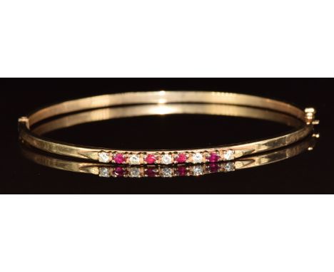 A 9ct gold bangle set with rubies and cubic zirconia, 5.2g, 5.5 x 6cm&nbsp;
