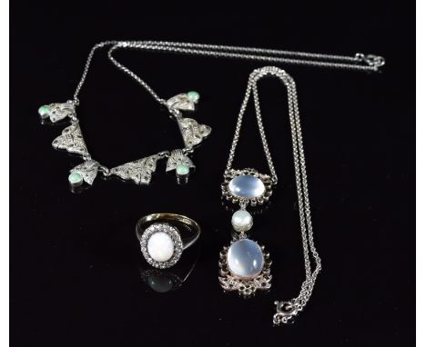 A 9ct gold ring set with an opal cabochon surrounded by paste in a silver setting and two silver necklaces, one set with moon