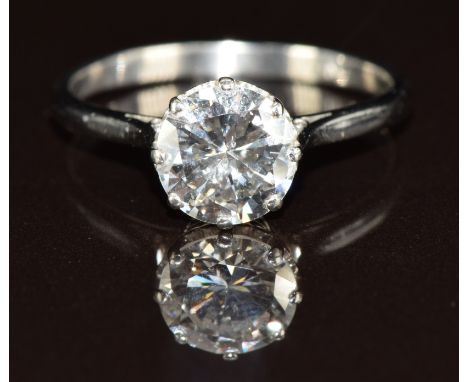 A platinum ring set with a round cut diamond of approximately 1.5ct, 3.4g, size O