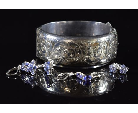 A silver bangle and three pairs of silver earrings set with tanzanites, 42g&nbsp;
