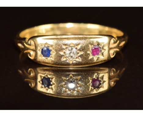 An 18ct gold ring set with a diamond, sapphire and ruby, all in star settings, 3.1g, size R