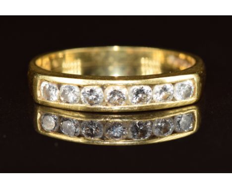 An 18ct gold ring set with seven diamonds, the total diamond weight approximately 0.3ct, 3.1g, size N