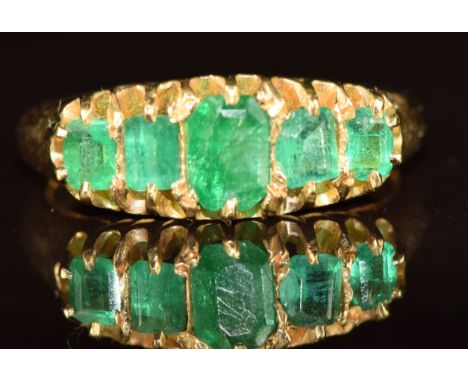 A Victorian 18ct gold ring set with five emerald cut emeralds, Chester 1895, 4.1g, size L