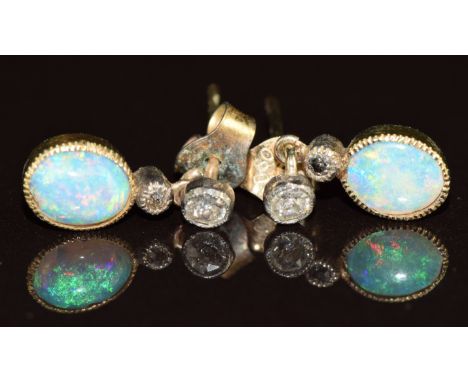 A pair of Victorian / Edwardian earrings each set with an opal cabochon and two old cut diamonds, 1.7g