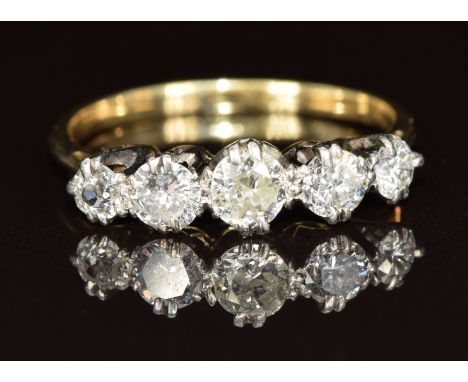 An 18ct gold ring set with five diamonds, the centre diamond approximately 0.2ct, 2.1g, size O