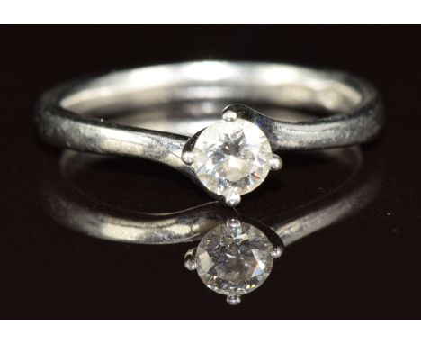 A platinum ring set with a round cut diamond of approximately 0.26ct, 3.5g, size K