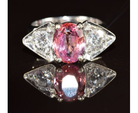 An 18k white gold ring set with a 2.5ct oval cut natural untreated Sri Lankan sapphire and two diamonds of approximately 0.4c