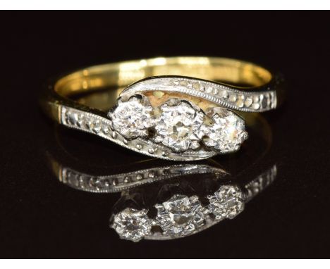 An 18ct gold ring set with three diamonds in a platinum setting, 3.1g, size J