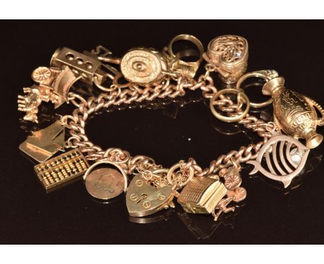 A 9ct gold charm bracelet with fifteen 9ct gold charms including 'marriage certificate' stanhope, ring box, fish, record play