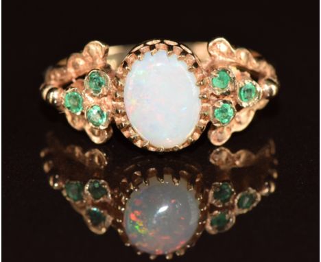 A 9ct gold ring set with an opal and emeralds, 2.1g, size M