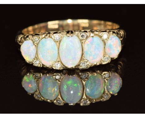 A 9ct gold ring set with five opal cabochons and diamonds, 3.8g, size O