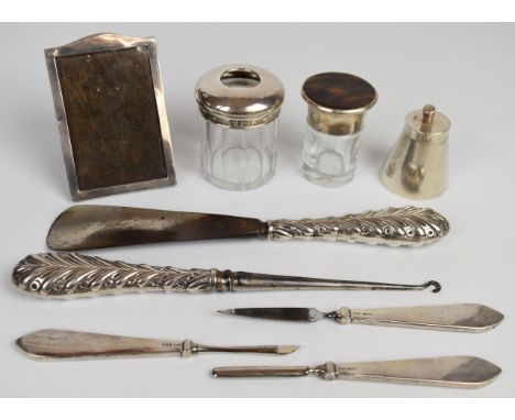 Hallmarked silver mounted items comprising photograph frame, height 10cm, button hook and shoe horn, three manicure tools and