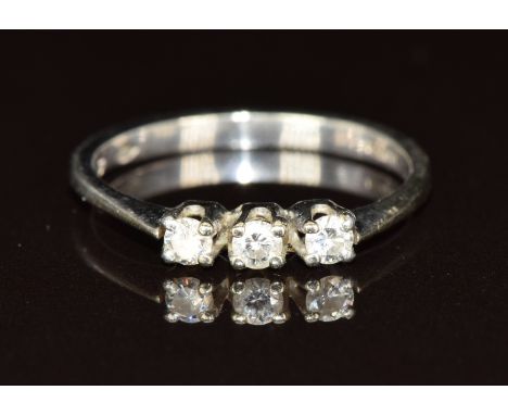An 18ct white gold ring set with three diamonds, 2.1g, size L
