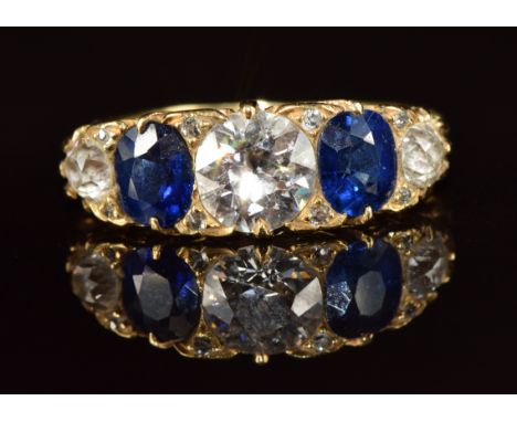A c1900 18ct gold ring set with a diamond of approximately 1ct, two oval cut sapphires each approximately 0.4ct,&nbsp;two fur