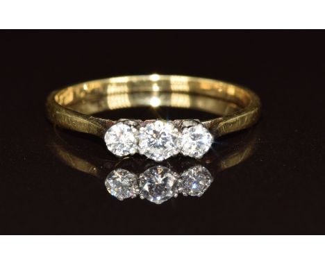 An 18ct gold ring set with three diamonds, 1.5g, size N