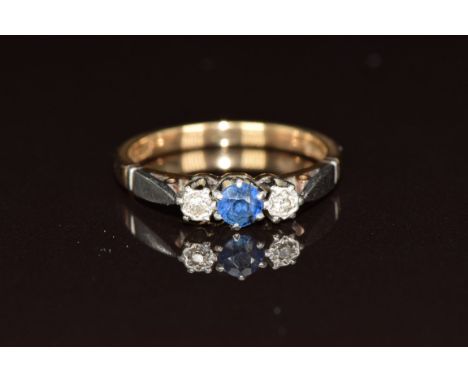 A 9ct gold ring set with a round cut sapphire and two diamonds in a platinum setting, 2.4g, size L