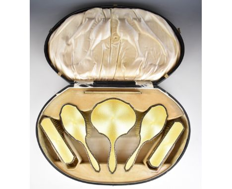 Art Deco cased hallmarked silver and yellow guilloch&eacute; enamel dressing table set comprising hand mirror, four brushes a