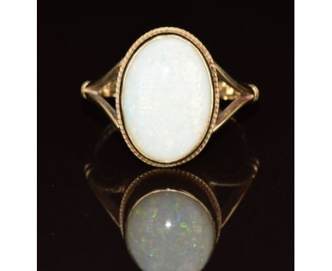 A 9ct gold ring set with an oval opal cabochon, 3.6g, size O