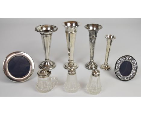 Hallmarked silver items comprising four trumpet vases, two photograph frames and a cut glass silver mounted cruet set, height