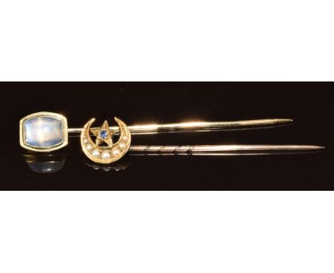 A 9ct gold stick pin set with a moonstone (1.4g) together with an Edwardian 15ct gold stick pin set with a sapphire and seed 