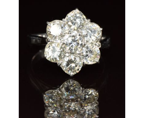 An 18ct white gold ring set with seven diamonds of approximately 0.4ct each in a cluster setting, 6.3g, size Q