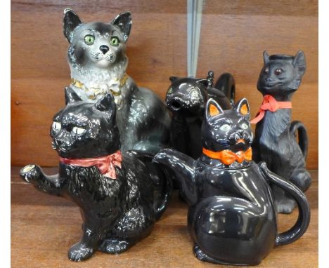 Three cat teapots including Carlton Ware and Shorter and Son, a Bretby cat candlestick with handle and a Staffordshire cat, s