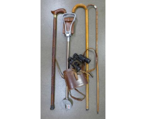 Three walking canes, a shooting stick and a pair of binoculars, 10 x 32