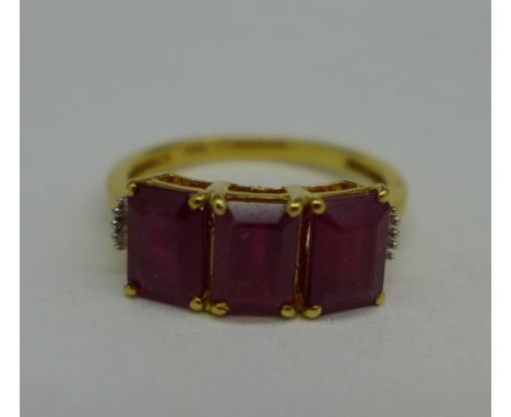 A silver gilt, ruby and diamond ring, O